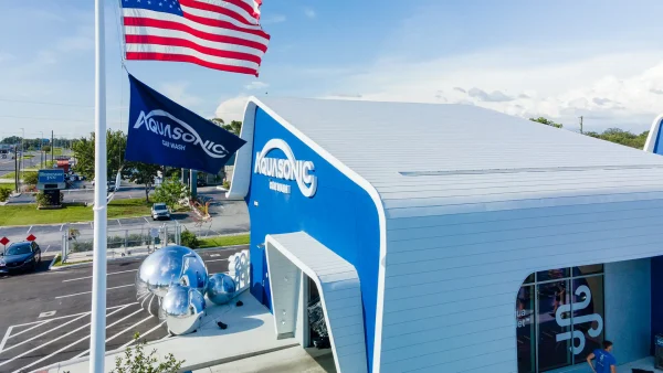 AquaSonic Car Wash Exterior with American and AquaSonic Flags